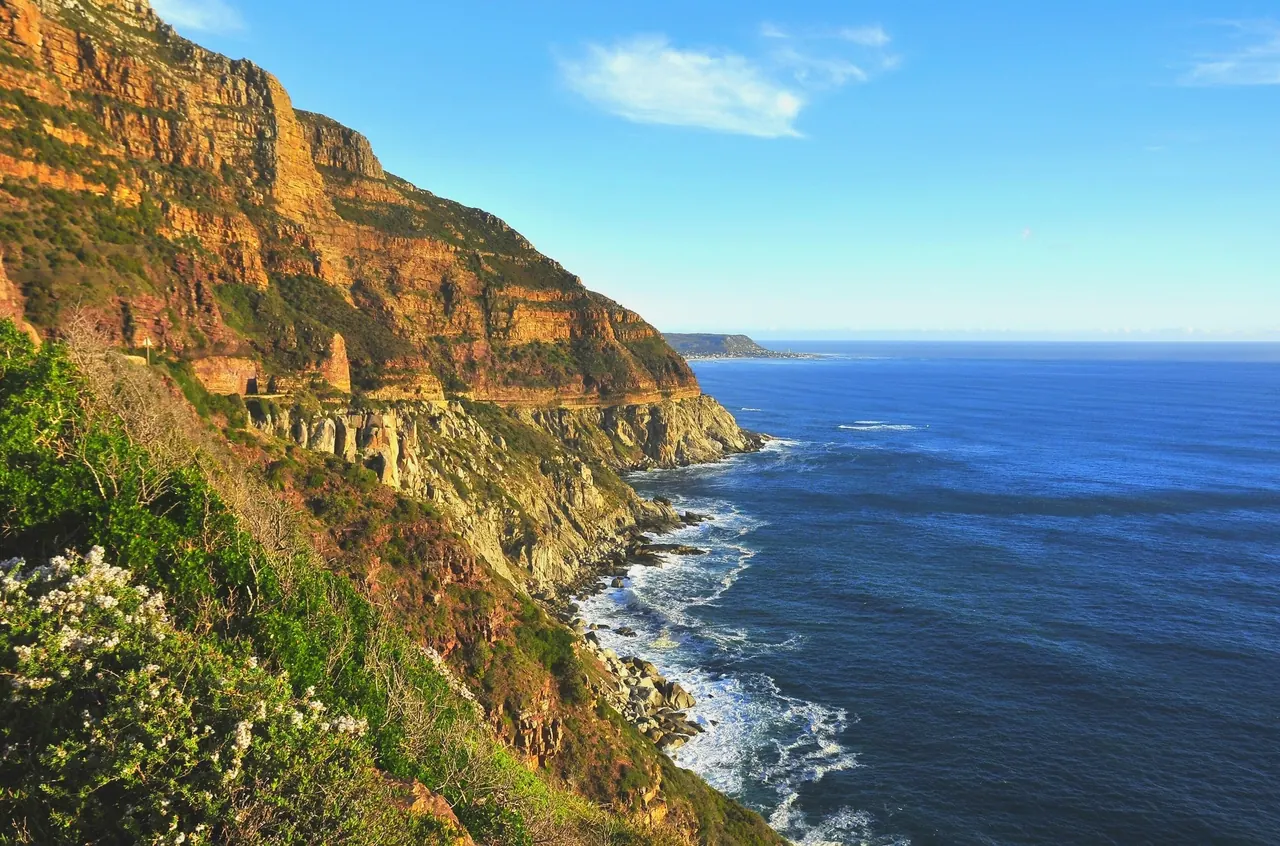A coastal road north of Durban with the sea on the right and sugar cane on the inland side.